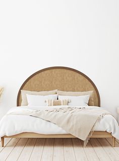 the bed is made up with white linens and pillows, along with two side tables