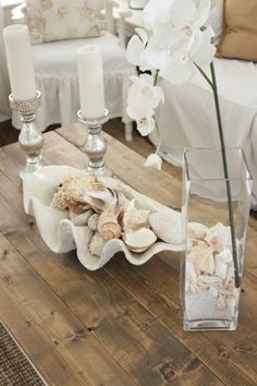 a coffee table with candles and seashells on it, along with the words starfish cottage diy