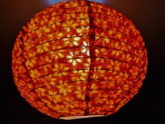 a close up view of a lit orange lantern