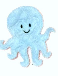 an octopus with a smile on it's face is shown in the shape of a hand embroidered applique