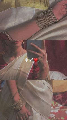 a woman in a white sari is holding her hand up to the side with a red heart on it