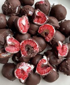 chocolate covered blood oranges are sitting on a plate