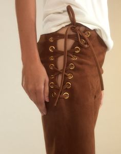 Straight leg lace-up pants in brown suede Premium suede Straight-leg silhouette High rise Adjustable lace-up sides with gold eyelets Rich caramel brown Fabric content: 100% leather Care instructions: dry clean only Fit: model is 5'10" and wears a size 4. Size 4 measurements: Length: 44" Complete the look: Mica Sleeveless Knit Top Suede Pants Outfit, Color Leather Pants, Suede Pants, Sleeveless Knit Top, Knit Alpaca, Sleeveless Knit, Favorite Daughter, Caramel Brown, A Perfect Circle