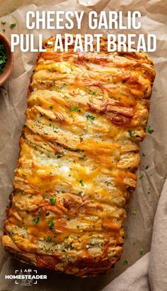 cheesy garlic pull apart bread with cheese and parsley in the middle on parchment paper