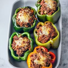 stuffed peppers with meat and cheese in a baking dish