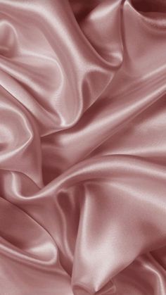 a close up view of a pink satin fabric