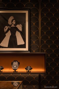 an art deco display with black and white artwork on the wall