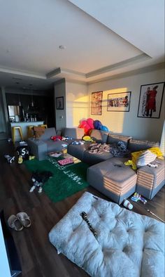 a living room filled with furniture and lots of clutter on top of the floor