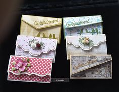 three cards with flowers and birds on them, one has a name tag attached to it