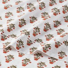 an image of a white fabric with red berries on it