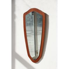 a mirror mounted to the side of a wall