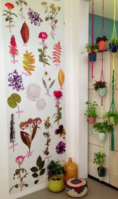 the wall is decorated with flowers and plants