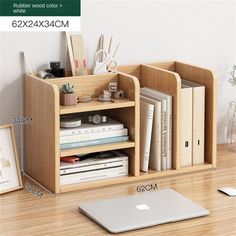 an apple computer sitting on top of a wooden desk next to a book shelf filled with books