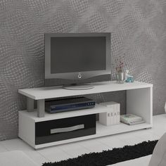 a flat screen tv sitting on top of a white entertainment center