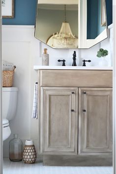 a bathroom with a sink, mirror and toilet in it's centerpieces