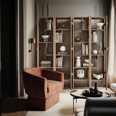 a living room filled with furniture and bookshelves