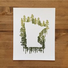 a piece of paper that has some trees in the shape of a letter on it