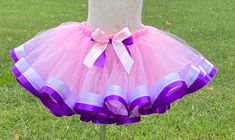 Celebrate any occasion in this ribbon trimmed tutu . Perfect for parties, celebrations,  recitals, dance and every day wear. Tutus are made on a stretch elastic for a comfortable fit.  Ribbon is sewn on. Your little one will be the center of attention in this beautiful tutu. If you would like another color combination or a size other than what is listed please send me a message. If you need your order faster than my current turnaround you will need to purchase the Rush My Order listing as well. Cute Purple Tutu Dress For First Birthday, Purple Cute Tutu Dress For First Birthday, Purple Tulle Tutu Dress For Birthday, Cute Purple Tulle Tutu Dress, Purple Smash Cake, Ribbon Tutu, Tutu Pink, Ribbon Trim Tutu, Purple Tutu