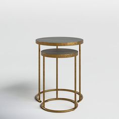 two round tables with gold metal bases and grey marble tops, on a white background