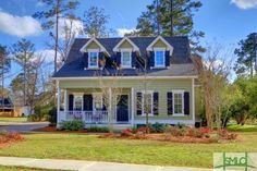 a white house with blue shutters on the front