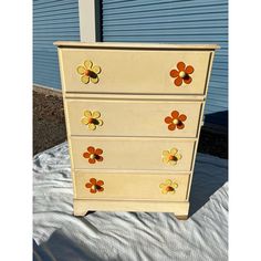 an old dresser has flowers painted on it