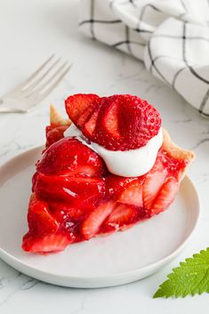 a slice of strawberry pie with whipped cream on top