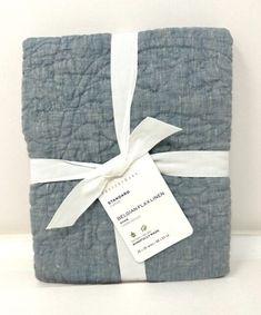 a blue and white blanket with a tag on it