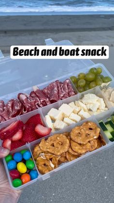 a plastic container filled with different types of food next to the ocean and beach text reads, beach and boat snack