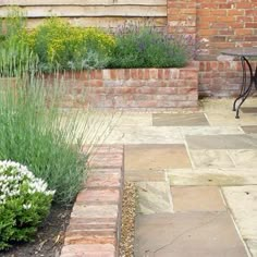 an outdoor patio area with brick walls and plants