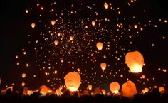 many lanterns floating in the air at night