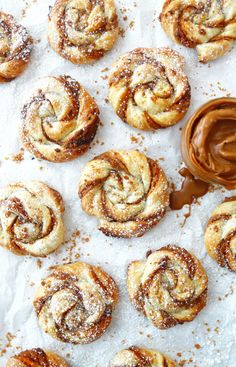 cinnamon rolls with powdered sugar and chocolate spread on the top, ready to be eaten