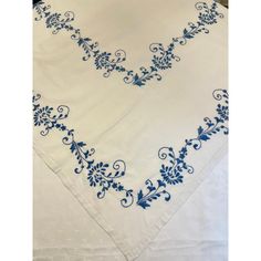 a white table cloth with blue flowers on it