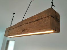 a wooden light fixture hanging from a ceiling