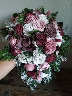 a bridal bouquet with purple and white flowers