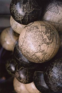 several wooden globes stacked on top of each other