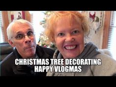 an older man and woman are smiling for the camera with christmas tree decorating happy vlogmas