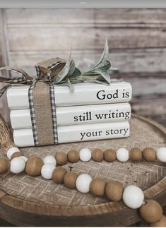 a stack of books sitting on top of a table next to a string of beads