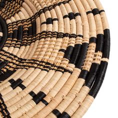 black and tan woven basket on white background