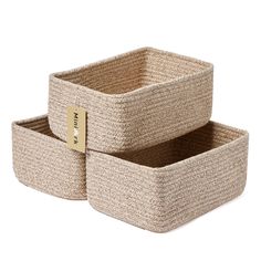 two baskets with labels on them sitting side by side in front of a white background