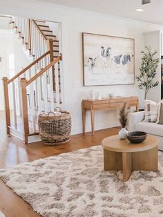 a living room filled with furniture and a stair case