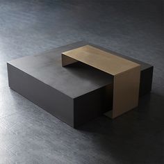 a black and gold table sitting on top of a gray floor