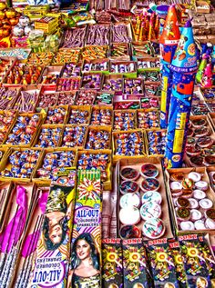 there are many different items on display at the market table, including pens and buttons