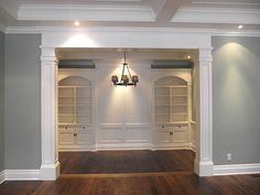 an empty room with built in bookshelves and hard wood flooring is shown