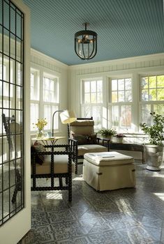 a living room filled with furniture and lots of windows