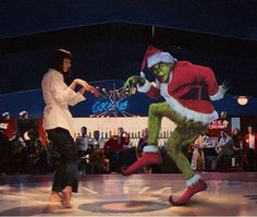 two people dressed up as the grinch and person dancing in front of an audience