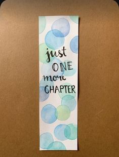 a piece of paper that says just one more character on it with blue and green circles