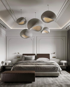 a large bed sitting in the middle of a bedroom next to two lamps above it