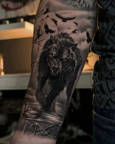 a man with a wolf tattoo on his arm