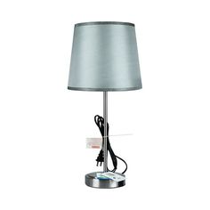 a lamp that is sitting on top of a metal base with a light bulb plugged into it