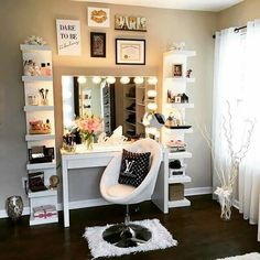 a room with a vanity, mirror and lights on the wall next to a window